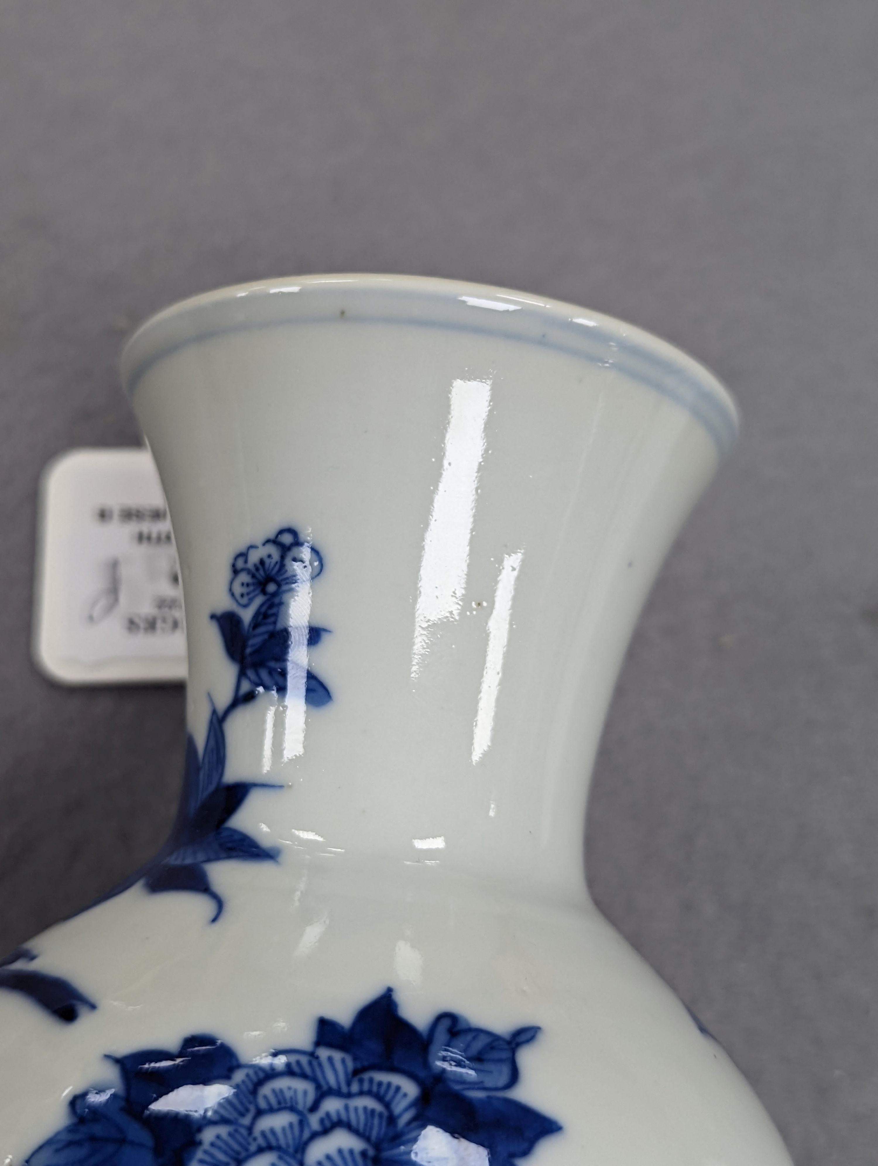 A late 19th century Chinese blue and white baluster vase, painted with birds amid flowers and rock work, pseudo Kangxi mark. 26cm